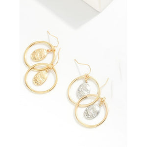 Gold hoop earrings with circular designs on a white background
