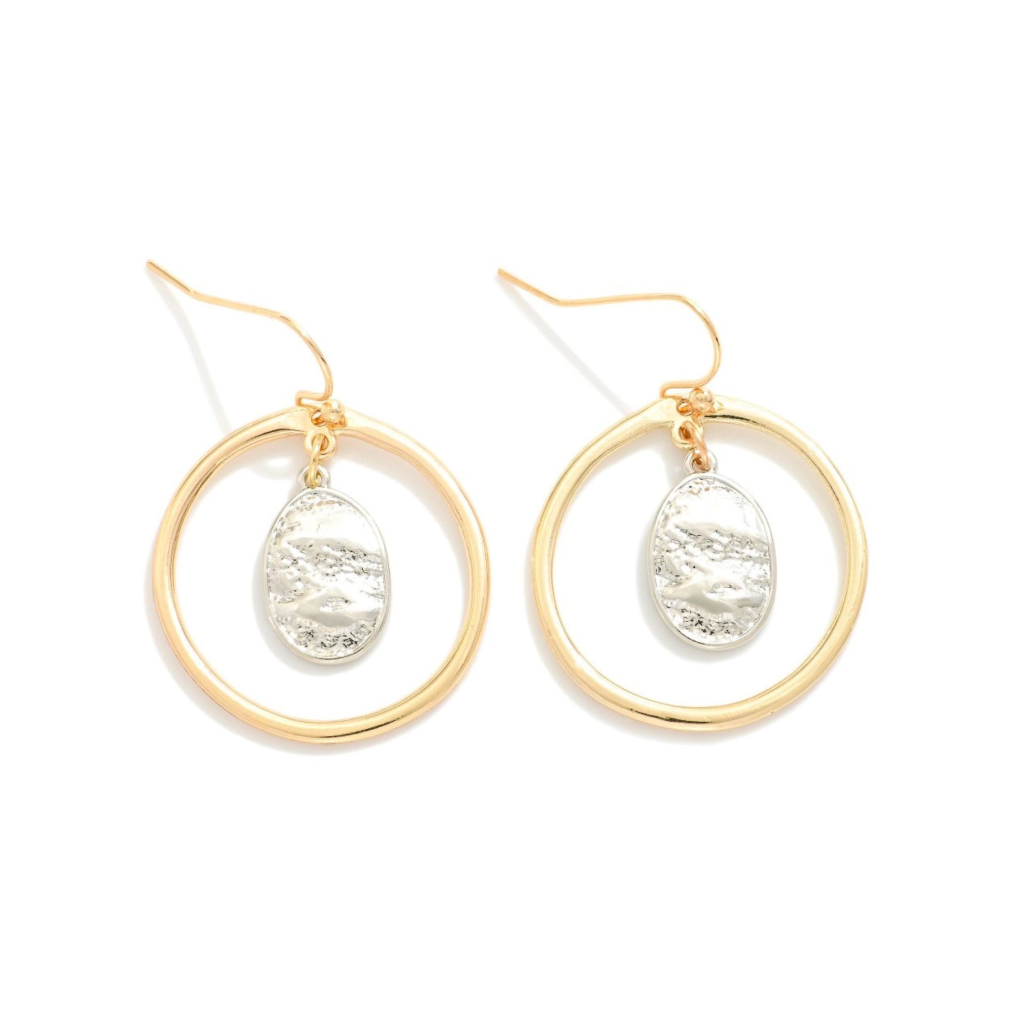 Gold hoop earrings with circular designs on a white background