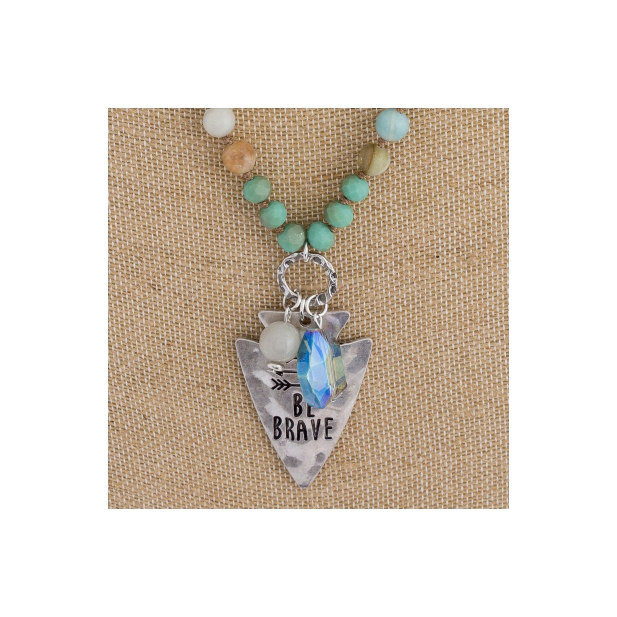 Long beaded necklace with engraved message, "Be brave."