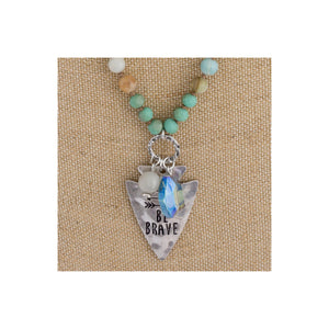 Long beaded necklace with engraved message, "Be brave."